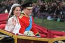 Kate and William travel in the 1902 State Landau along the processional route to Buckingham Palace after their wedding (Dimitar Dilkoff/PA)