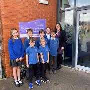 Earsham CofE Primary headteacher Heather Brand and pupils mark the school joining DNEAT