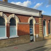 A bystander peers into the window of the former Halifax branch in Beccles which could be transformed into a bar should plans be approved