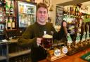 Pub landlord James Pickard with a pint of the Green Dragon's famous Chaucer Ale