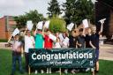 Langley students wave their results gleefully.
