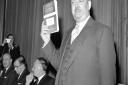 Dr Richard Beeching holding aloft a copy of the pamphlet 'The Reshaping of British Railways'. PIC: PA Wire