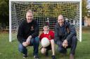 05/11/14 - Peter Robson (left) and Mark Harrod of Mark Harrod Ltd with nine-year-old Tobey Fergusan in front of the new football nets that they provided for Weeke Primary School in Winchester. Mark Harrod Ltd offered the nets to the school after pupil Tob