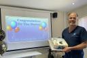 Dr Tim Morton with his cake to celebrate 40 years of treating patients