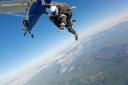 James Paget Hospital housekeeper Kim Cox at 3,000 feet for her skydive in Beccles. Picture - UK Parachuting
