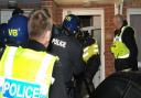 Police raid a property as part of a modern slavery investigation