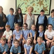 Lynda is pictured with some of the children she has taught from reception up to year six.