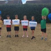 Pupils in the Woodpecker class at Ditchingham Church of England Primary Academy celebrate their 'Good' Ofsted rating.