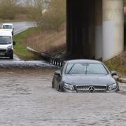 A car is stuck in flood water under the A11 on the Hargham Road during Storm Franklin. Byline: Sonya Duncan