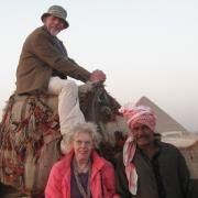 The happy couple: Patricia Rolls (left) pictured with her husband, Alec (above), and their tour guide in Eygpt