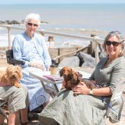 Hazel Parker, Serena Plenderleith with Griselda, and Anneli Whyte with Myla and Gretel on the Suffolk coast