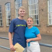 Tom Mackinson (left) and his girlfriend, Katie Lamy, smile having collected their results.