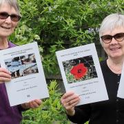 Authors Elvie Herd (left) and Carol Webb (right) smile with the three books they now have on sale at Loddon library.