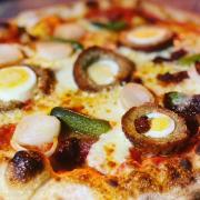 The 'substantial meal' pizza at Oakfired. Toppings are scotch egg, pickles and cheese.