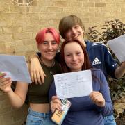 Georgia Flatt (left), Lia Belson (centre) and Charles Brooke (right) celebrate together as each of them are happy with their results.
