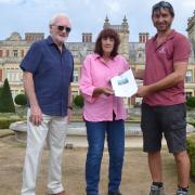 Paul Randle of Beccles Rotary Club is on the left, with Sue in the middle and Head of Gardens Simon Gaches on the right, presenting the voucher certificate.