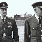 Flt Lt James Betteridge, left with sword, and a senior officer at a ceremonial parade at RAF Kinloss in Scotland in the 1950s.