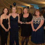 Chief executive Ian Hutchison (right) presents ECCH\'s Infection Prevention and Control team with the Clinical Team of the Year award.