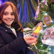 Lillie-Mae Vyse, nine, with a picture of herself on the Centenatree by the 1st Beccles Brownies at the 2021 Hungate Church Christmas tree festival in Beccles, as the pack celebrated their centenary.