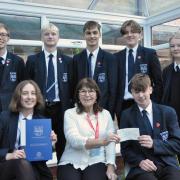 Beccles Rotary Club treasurer and junior vice president, Theresa Robinson, hands over the cheque to Sir John Leman High School.