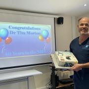Dr Tim Morton with his cake to celebrate 40 years of treating patients