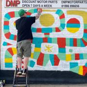 Internationally commissioned artist Vinnie Nylon painting on Lower Olland Street in Bungay