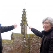 Church secretary and fabric officer Simon Wilkin (left) and the churchwarden Sally Ellson (right) pictured with the fractured pinnacle behind them