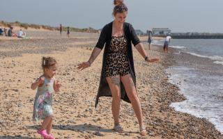 Gemma Sharp and Primrose Taylor Mockett enjoying the sunshine on the beach in Walberswick.